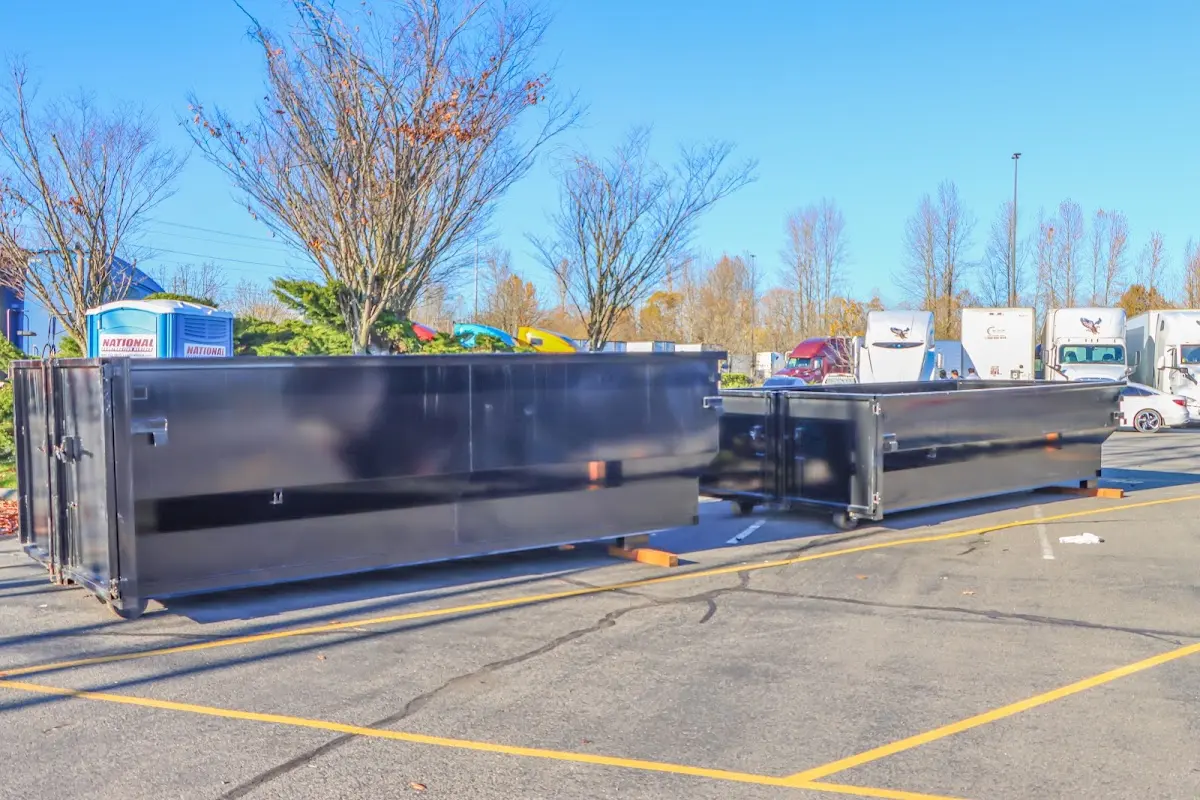 Professional dumpster rental service with roll-off container on residential driveway in Orcutt